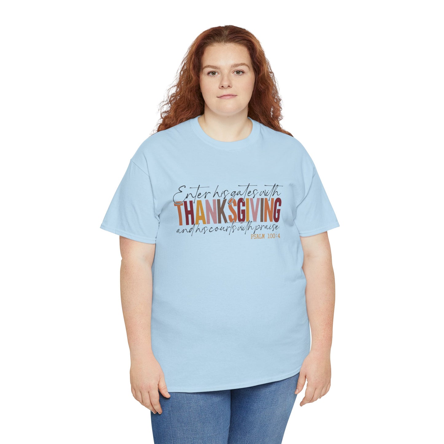 Woman wearing a white t-shirt that reads “Enter His Gates with Thanksgiving – Psalm 100:4,” styled with jeans, Christian faith-inspired fall outfit.