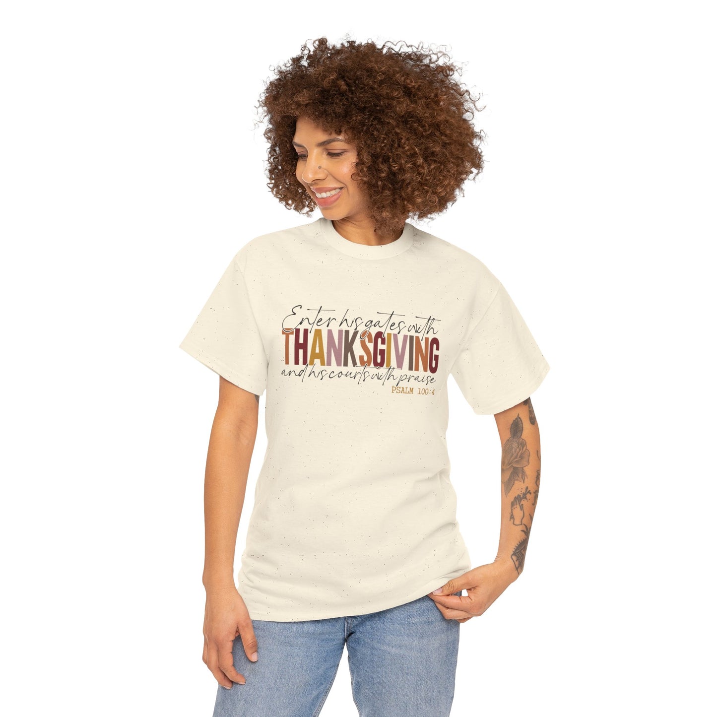 Woman wearing a white t-shirt that reads “Enter His Gates with Thanksgiving – Psalm 100:4,” styled with jeans, Christian faith-inspired fall outfit.