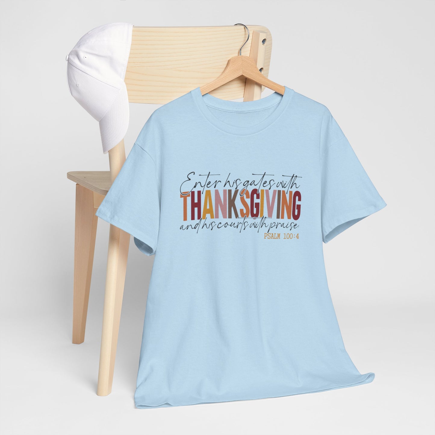 Woman wearing a white t-shirt that reads “Enter His Gates with Thanksgiving – Psalm 100:4,” styled with jeans, Christian faith-inspired fall outfit.