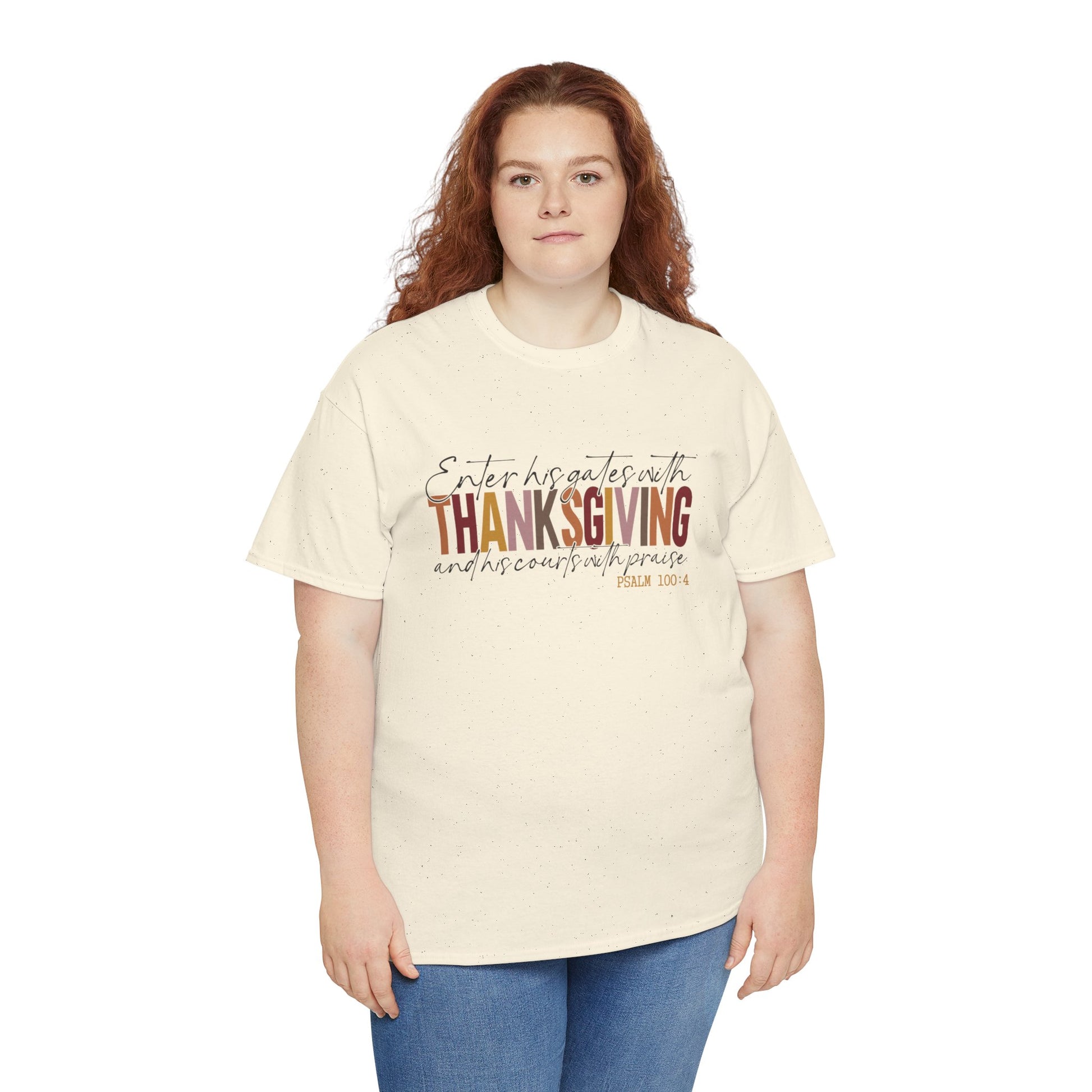 Woman wearing a white t-shirt that reads “Enter His Gates with Thanksgiving – Psalm 100:4,” styled with jeans, Christian faith-inspired fall outfit.